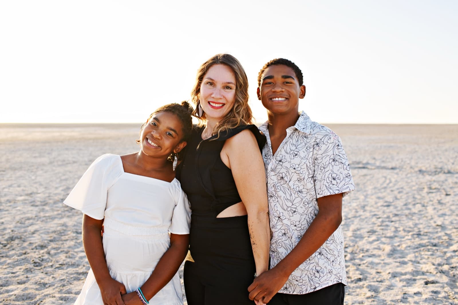 Rachel Patten with her children at sunset on the beach