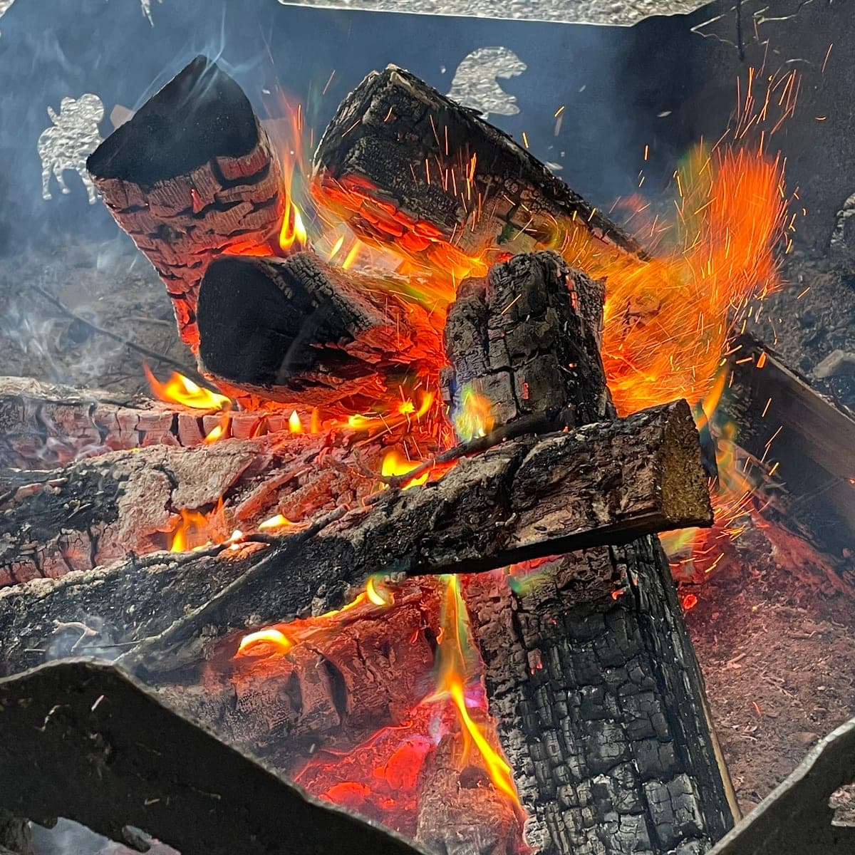 Logs blazing in a fire pit