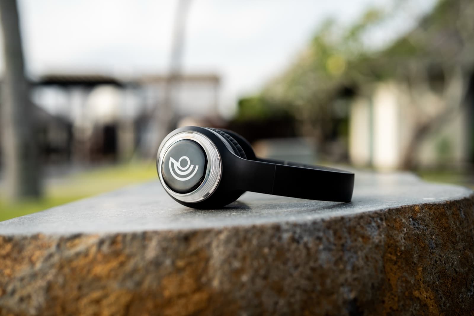 A 9D headset resting on a stone in a garden