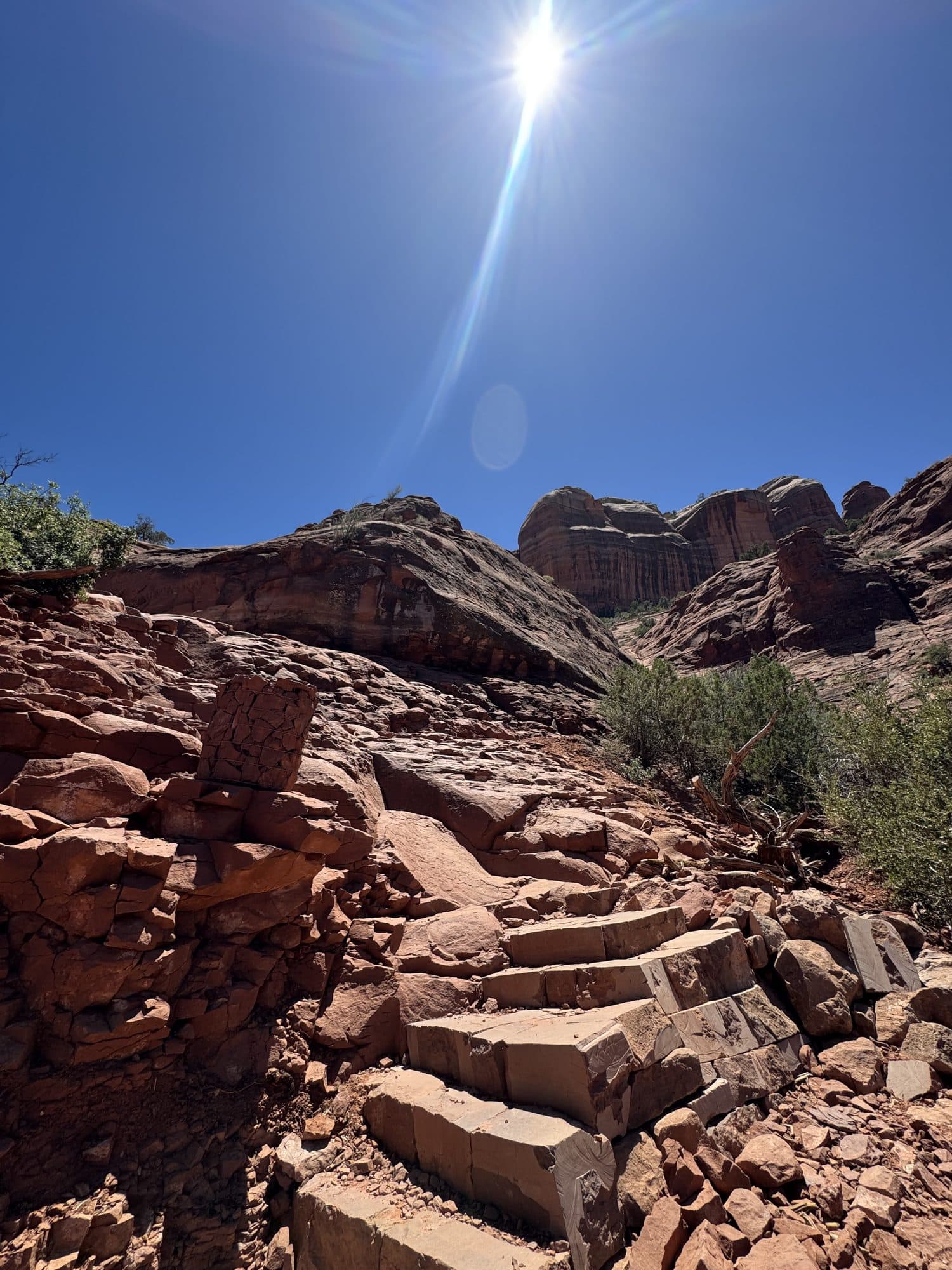 Worn red rock steps climbing toward the sun