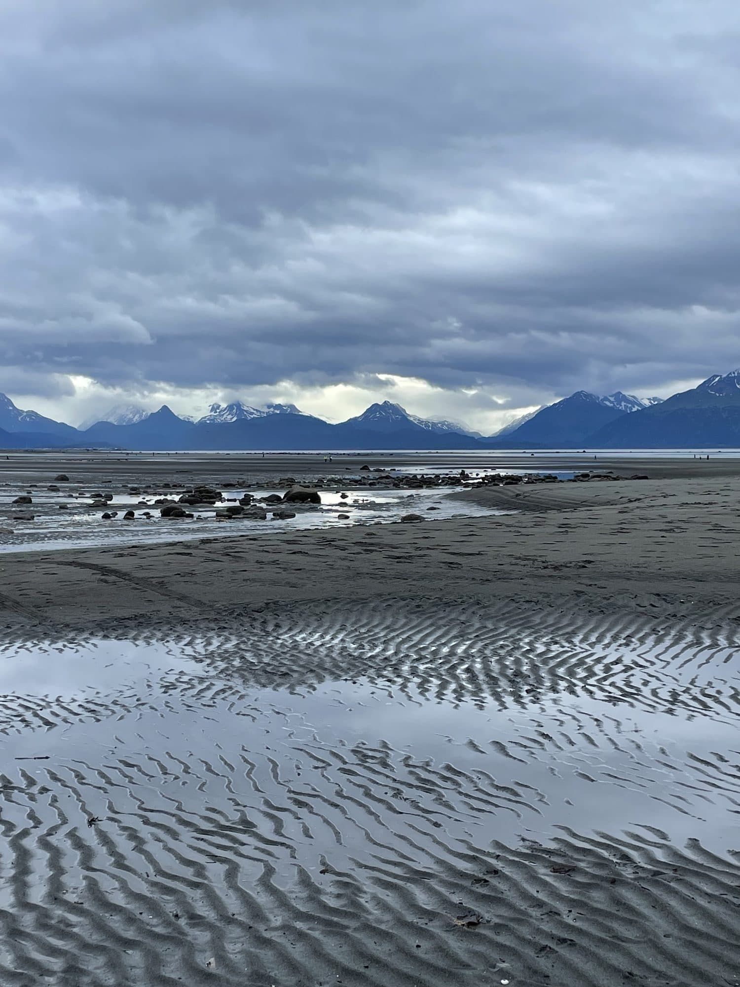 Shallow water over rippled sand, the sky in its surface