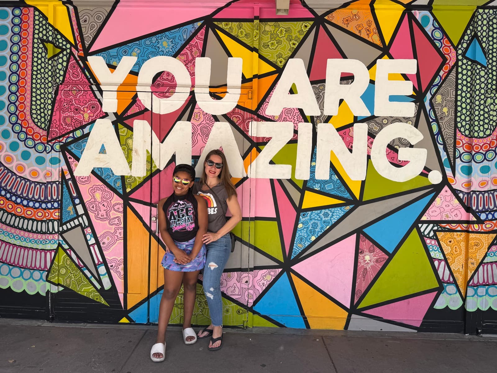 Rachel and her daughter at a 'You Are Amazing' street mural
